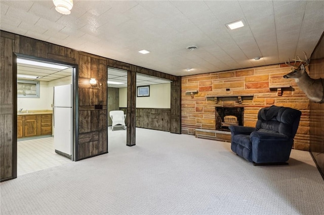 1509 Edmon Rd, Kiskiminetas Twp, PA 15618 - sitting room with wooden walls, light colored carpet, and a stone fireplace