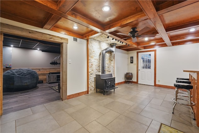 1125 Annisville Rd, Washington Twp But, PA 16050 - basement featuring a wood stove, baseboards, ceiling fan, tile patterned floors, and recessed lighting