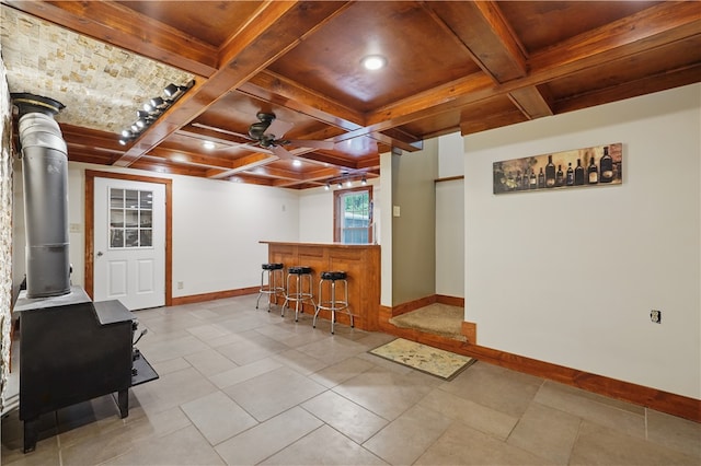 1125 Annisville Rd, Washington Twp But, PA 16050 - sitting room with baseboards, coffered ceiling, a wood stove, bar area, and beam ceiling