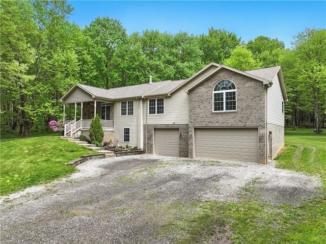 1125 Annisville Rd, Washington Twp But, PA 16050 - view of front of home featuring an attached garage, a porch, brick siding, a front yard, and gravel driveway