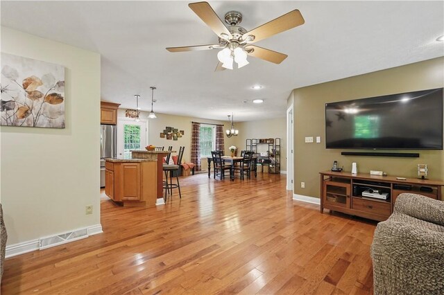 1125 Annisville Rd, Washington Twp But, PA 16050 - living room featuring light wood-style flooring, a ceiling fan, a chandelier, and baseboards
