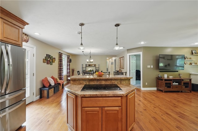 1125 Annisville Rd, Washington Twp But, PA 16050 - kitchen featuring freestanding refrigerator, black electric stovetop, light wood-style floors, a center island, and recessed lighting