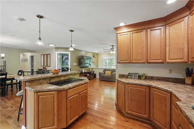 1125 Annisville Rd, Washington Twp But, PA 16050 - kitchen with light wood-type flooring, pendant lighting, recessed lighting, a kitchen bar, and ceiling fan