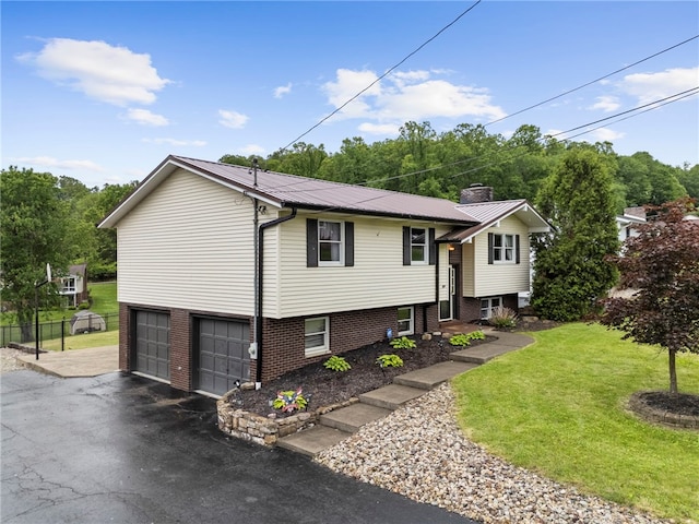 174 Hague Ln, South Union Twp, PA 15401 - view of front of property with a front lawn, metal roof, a chimney, an attached garage, and driveway