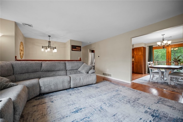 174 Hague Ln, South Union Twp, PA 15401 - living area featuring a chandelier, wood finished floors, and baseboards