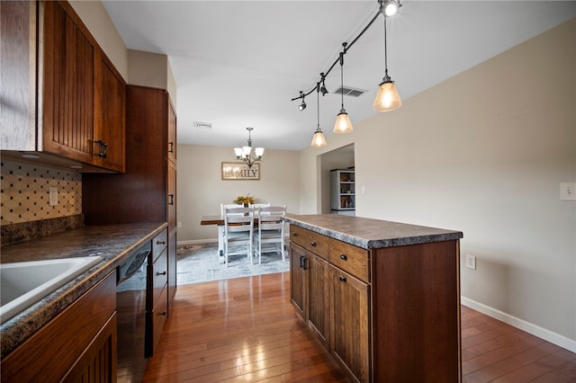 174 Hague Ln, South Union Twp, PA 15401 - kitchen featuring dark countertops, dishwashing machine, dark wood-style flooring, a chandelier, and baseboards