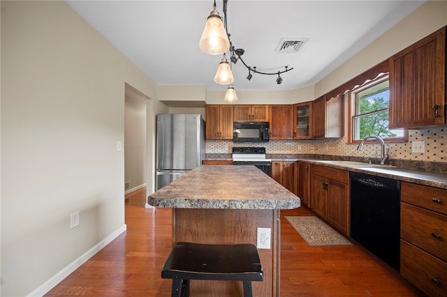 174 Hague Ln, South Union Twp, PA 15401 - kitchen featuring black appliances, a sink, decorative backsplash, and a center island