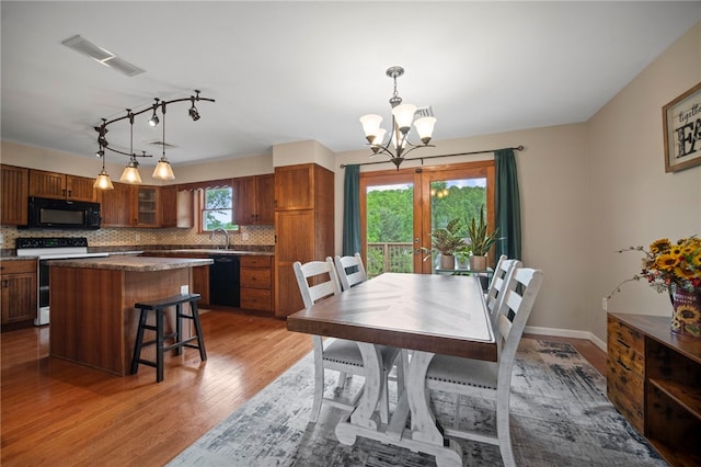 174 Hague Ln, South Union Twp, PA 15401 - dining area with a chandelier, light wood-style flooring, and rail lighting