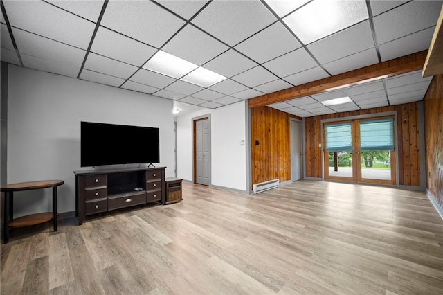 174 Hague Ln, South Union Twp, PA 15401 - unfurnished living room with wooden walls, baseboard heating, a drop ceiling, baseboards, and wood finished floors