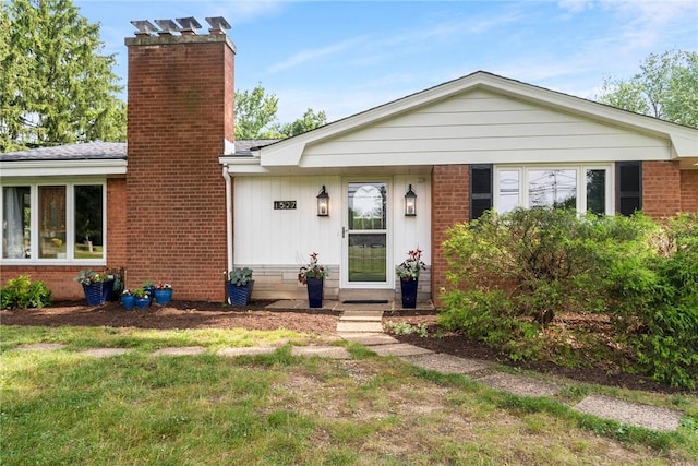 1527 W Ingomar Rd, Franklin Park, PA 15237 - view of front facade featuring a chimney, brick siding, a front yard, and board and batten siding