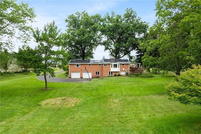 1527 W Ingomar Rd, Franklin Park, PA 15237 - rear view of property featuring an attached garage, driveway, a yard, and solar panels