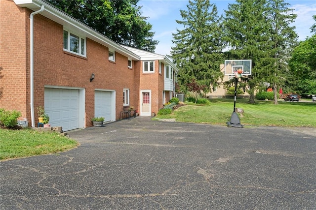 1527 W Ingomar Rd, Franklin Park, PA 15237 - view of home's exterior with an attached garage, asphalt driveway, a yard, central air condition unit, and brick siding