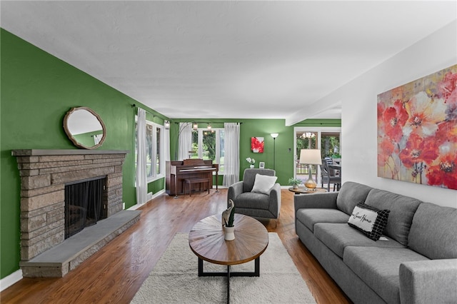 1527 W Ingomar Rd, Franklin Park, PA 15237 - living room featuring a fireplace with raised hearth, wood finished floors, and baseboards