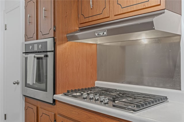 1527 W Ingomar Rd, Franklin Park, PA 15237 - kitchen featuring stainless steel appliances, under cabinet range hood, light countertops, and brown cabinetry