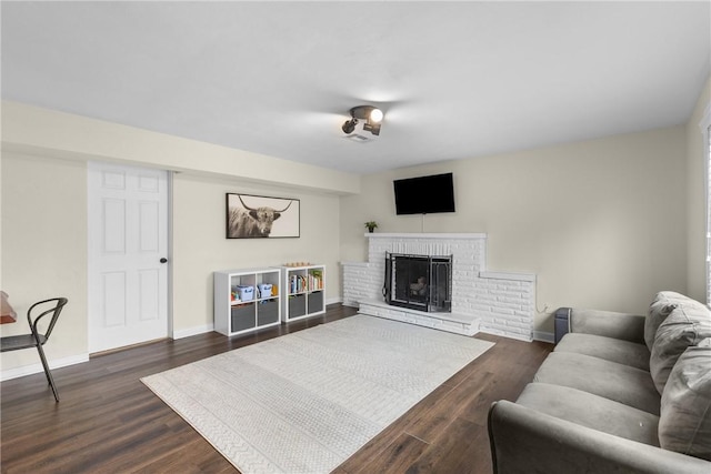 6032 Dalmation Dr, Bethel Park, PA 15102 - living area with a brick fireplace, dark wood-type flooring, and baseboards