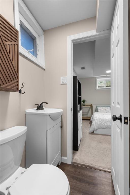 6032 Dalmation Dr, Bethel Park, PA 15102 - bathroom featuring toilet, vanity, and wood finished floors