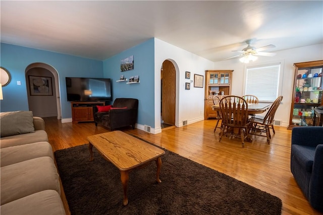 127 Burns Ave, Chippewa Twp, PA 15010 - living room featuring arched walkways, wood finished floors, ceiling fan, and baseboards