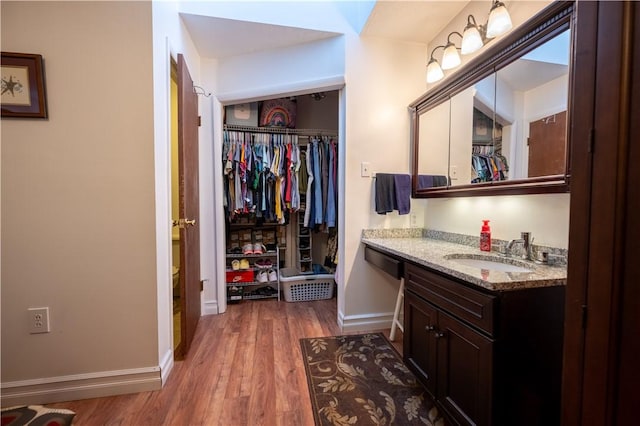 127 Burns Ave, Chippewa Twp, PA 15010 - bathroom with vanity, wood finished floors, baseboards, a walk in closet, and toilet