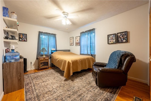 127 Burns Ave, Chippewa Twp, PA 15010 - bedroom with wood finished floors, baseboards, ceiling fan, and a textured ceiling