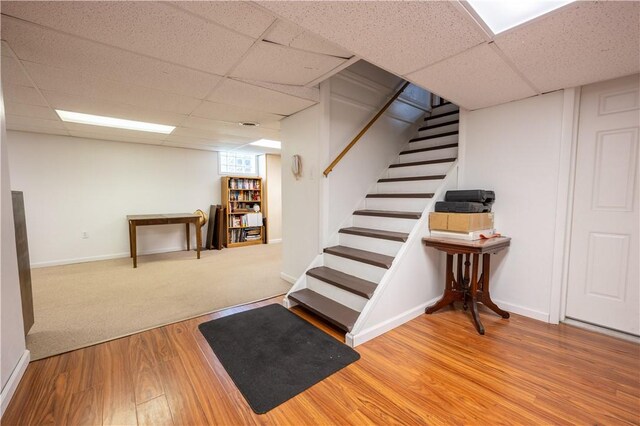 127 Burns Ave, Chippewa Twp, PA 15010 - finished below grade area with a paneled ceiling, wood finished floors, stairs, and baseboards