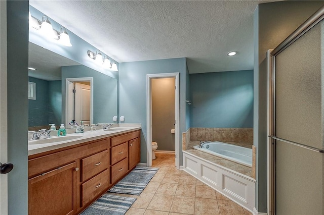 1517 Lombard Cir, South Strabane, PA 15301 - bathroom featuring toilet, a bath, double vanity, tile patterned flooring, and a textured ceiling
