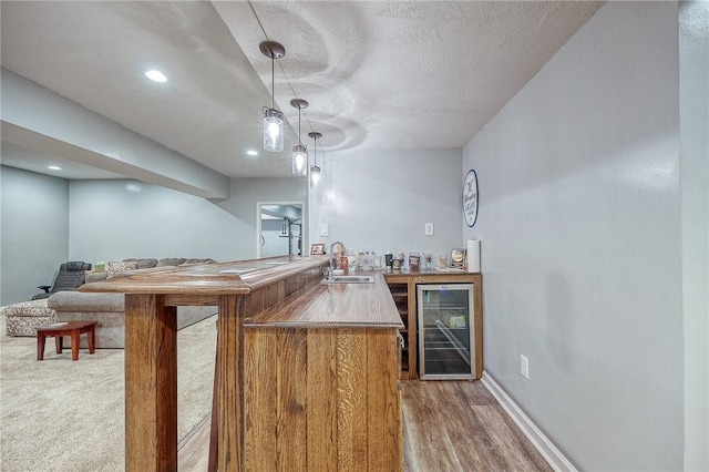 1517 Lombard Cir, South Strabane, PA 15301 - indoor wet bar featuring wine cooler, decorative light fixtures, wood finished floors, recessed lighting, and a textured ceiling