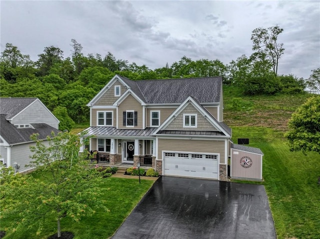 1517 Lombard Cir, South Strabane, PA 15301 - craftsman house with a standing seam roof, a porch, asphalt driveway, metal roof, and a front lawn
