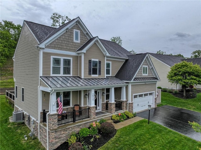 1517 Lombard Cir, South Strabane, PA 15301 - craftsman-style house with a porch, a standing seam roof, asphalt driveway, cooling unit, and metal roof