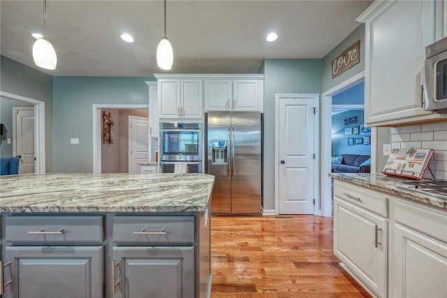 1517 Lombard Cir, South Strabane, PA 15301 - kitchen featuring appliances with stainless steel finishes, gray cabinetry, light wood-type flooring, decorative light fixtures, and white cabinetry