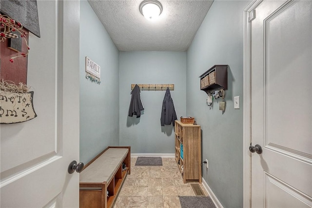 1517 Lombard Cir, South Strabane, PA 15301 - mudroom featuring a textured ceiling and baseboards