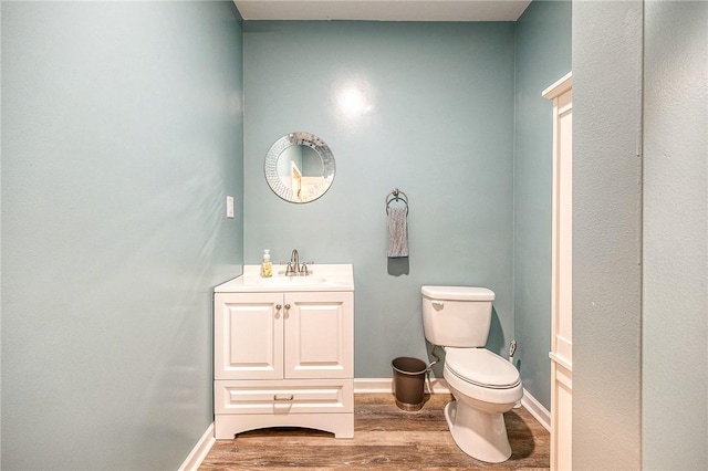 1517 Lombard Cir, South Strabane, PA 15301 - half bathroom featuring vanity, toilet, wood finished floors, and baseboards