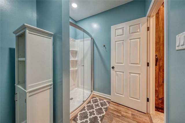 1517 Lombard Cir, South Strabane, PA 15301 - bathroom featuring a stall shower, wood finished floors, and baseboards