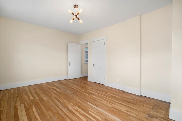 1727 Morningside Ave, Morningside, PA 15206 - unfurnished bedroom featuring a chandelier, light wood-style flooring, and baseboards