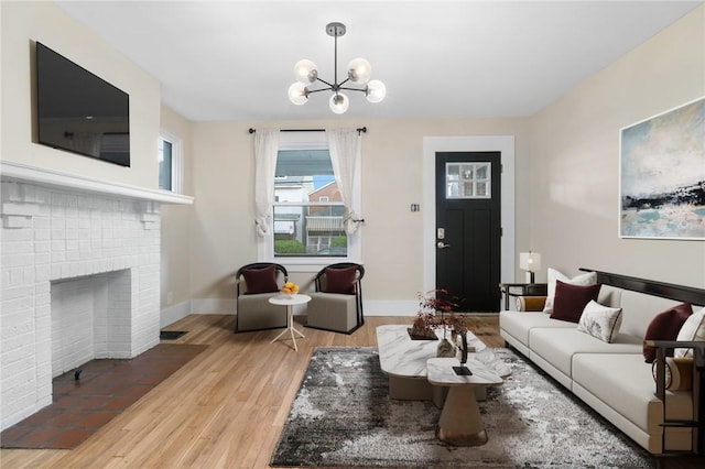 1727 Morningside Ave, Morningside, PA 15206 - living area featuring a chandelier, wood finished floors, baseboards, and a brick fireplace