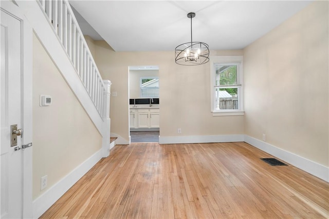 1727 Morningside Ave, Morningside, PA 15206 - unfurnished dining area with light wood-style flooring, stairs, plenty of natural light, and a sink
