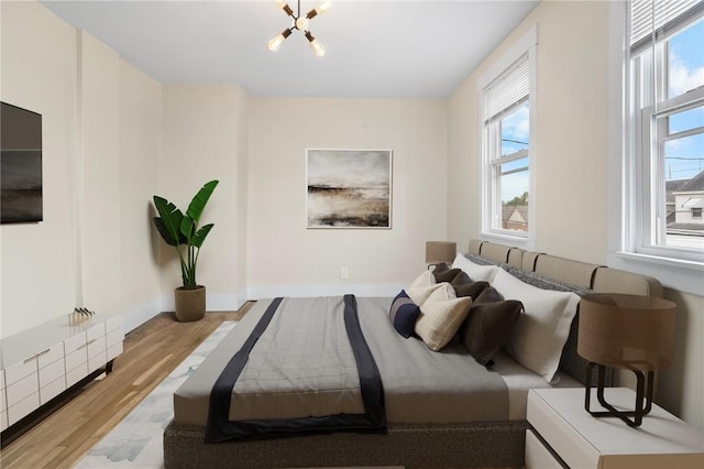 1727 Morningside Ave, Morningside, PA 15206 - bedroom featuring multiple windows, wood finished floors, and a chandelier