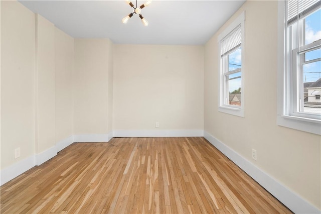 1727 Morningside Ave, Morningside, PA 15206 - empty room with a chandelier, healthy amount of natural light, light wood-style floors, and baseboards