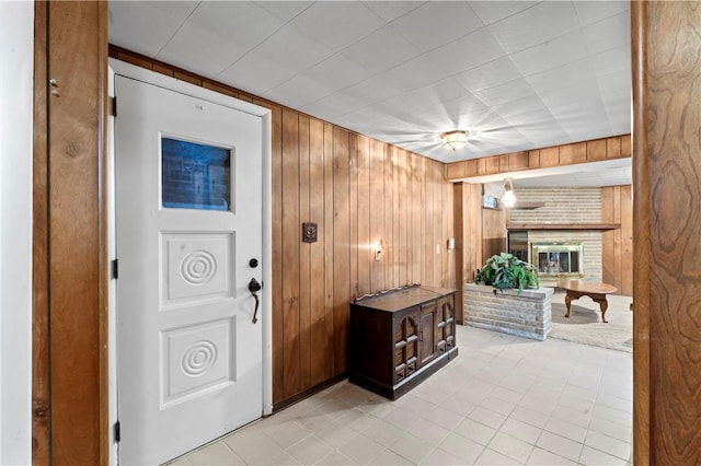 146 Samuel St, Chippewa Twp, PA 15010 - foyer with wooden walls, a fireplace, and light tile patterned flooring