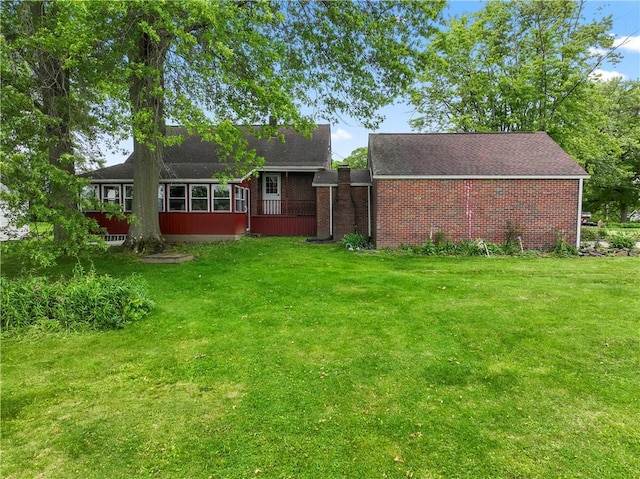 146 Samuel St, Chippewa Twp, PA 15010 - back of house featuring a lawn, brick siding, and a shingled roof