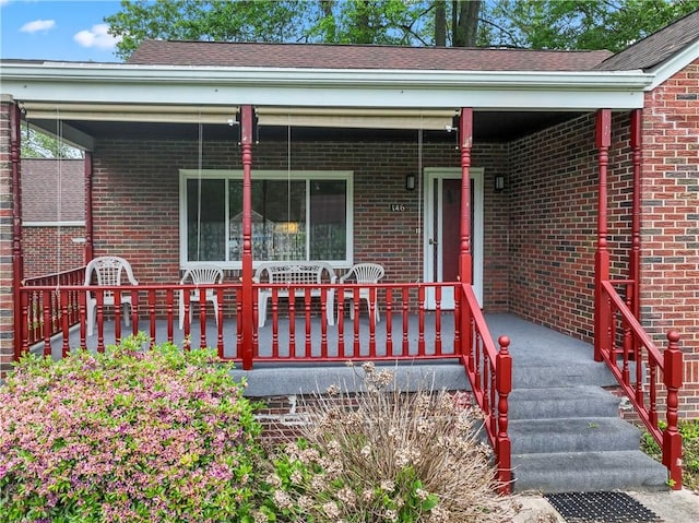 146 Samuel St, Chippewa Twp, PA 15010 - view of exterior entry featuring brick siding and a porch