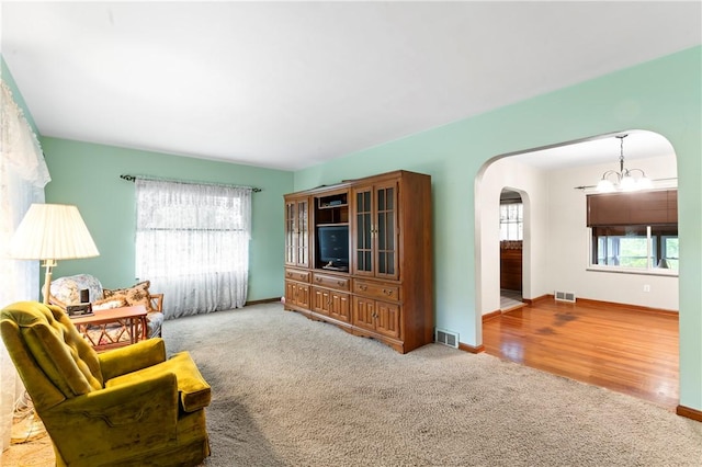146 Samuel St, Chippewa Twp, PA 15010 - carpeted living area with arched walkways, healthy amount of natural light, baseboards, and a chandelier