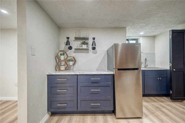 2425 W Pike St, Chartiers, PA 15342 - kitchen featuring freestanding refrigerator, light wood-type flooring, a sink, a textured ceiling, and light countertops
