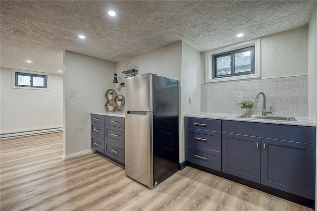 2425 W Pike St, Chartiers, PA 15342 - kitchen featuring freestanding refrigerator, light wood-style flooring, a textured ceiling, baseboard heating, and a sink