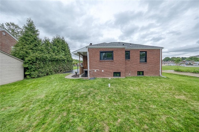 2425 W Pike St, Chartiers, PA 15342 - rear view of house featuring brick siding and a lawn