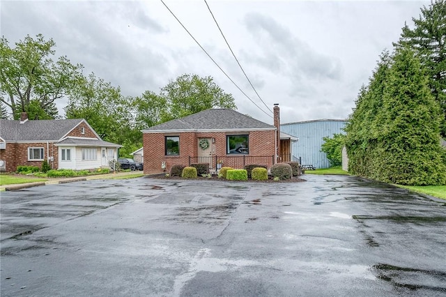 2425 W Pike St, Chartiers, PA 15342 - view of front of property with a chimney, brick siding, and asphalt driveway