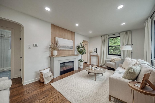 2425 W Pike St, Chartiers, PA 15342 - living room with arched walkways, recessed lighting, wood finished floors, a glass covered fireplace, and baseboards
