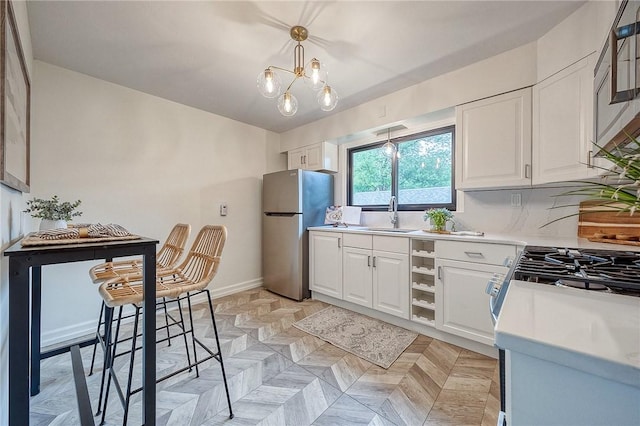 2425 W Pike St, Chartiers, PA 15342 - kitchen with freestanding refrigerator, a sink, white cabinets, light countertops, and baseboards
