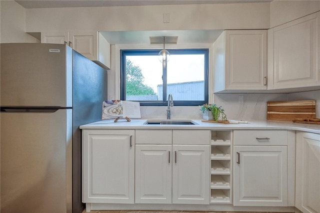 2425 W Pike St, Chartiers, PA 15342 - kitchen with freestanding refrigerator, a sink, white cabinetry, and light countertops