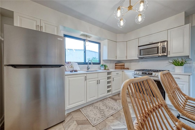 2425 W Pike St, Chartiers, PA 15342 - kitchen with stainless steel appliances, light countertops, a sink, and white cabinets