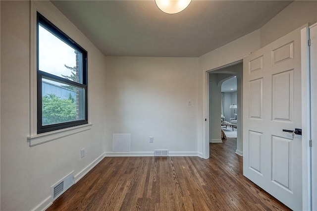 2425 W Pike St, Chartiers, PA 15342 - empty room with arched walkways, dark wood-style flooring, and baseboards